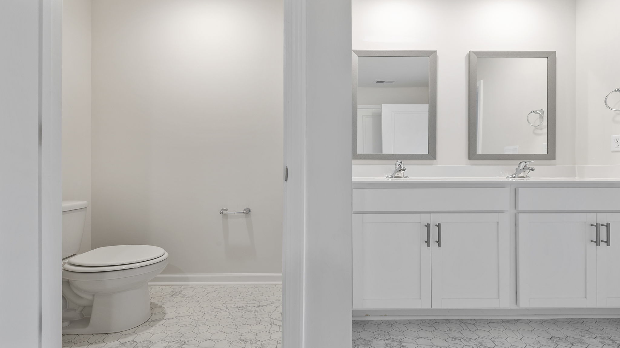 Primary bathroom with dual sink vanity.