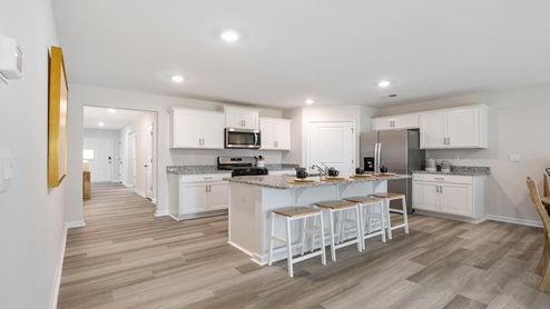 Kitchen and island with granite counter tops.