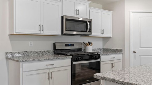 Kitchen and island with granite counter tops.