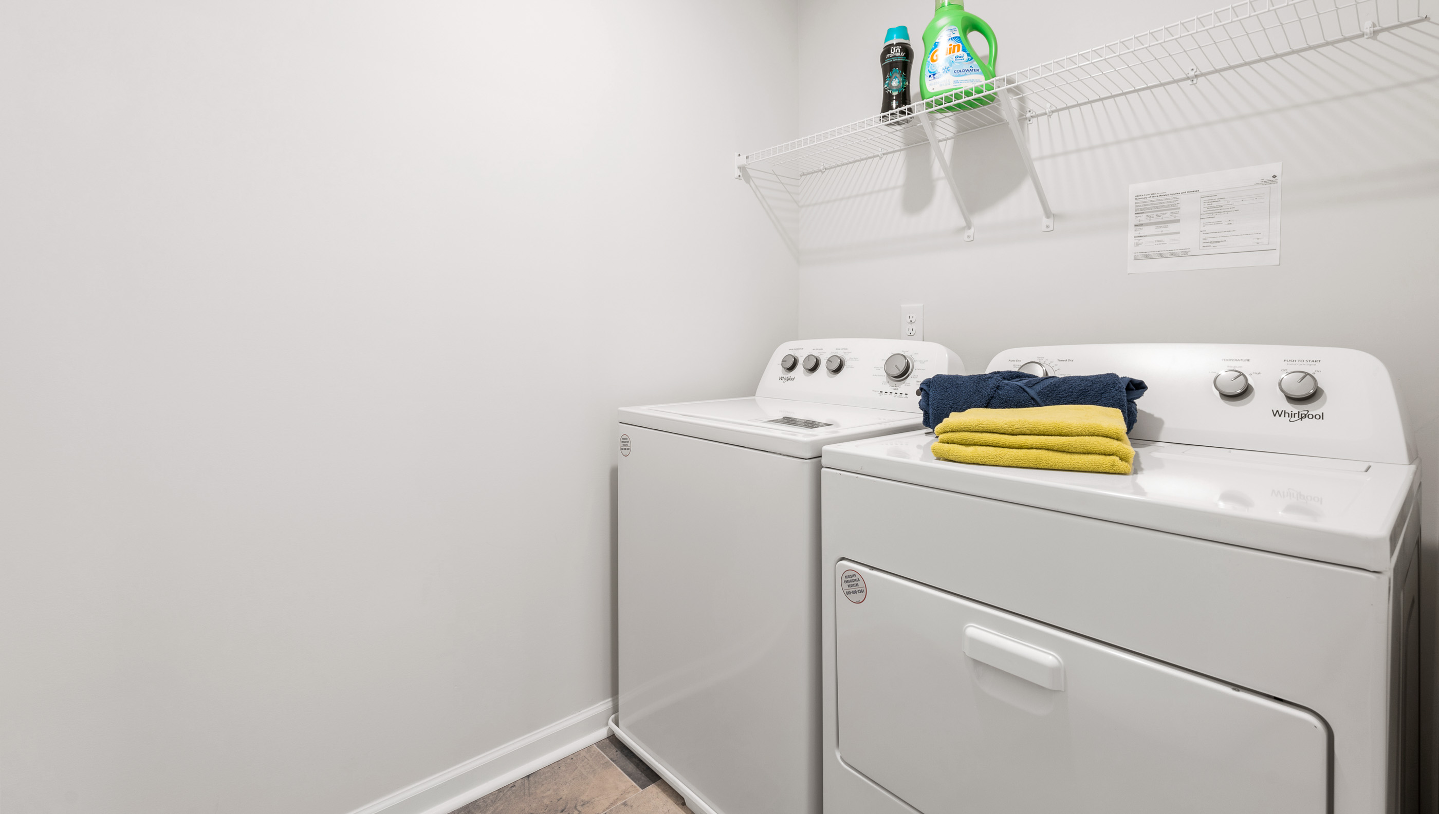 Laundry room with shel;f.