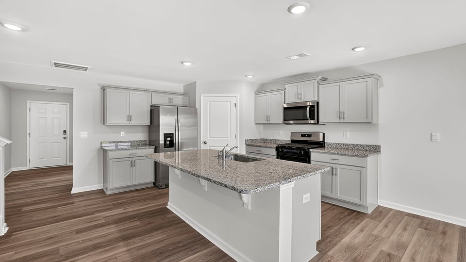 Kitchen with island and cabinets.