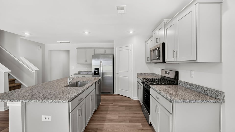 Kitchen with island and cabinets.