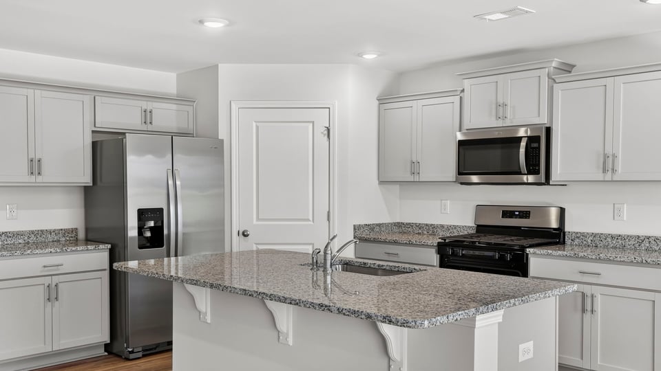 Kitchen with island and cabinets.
