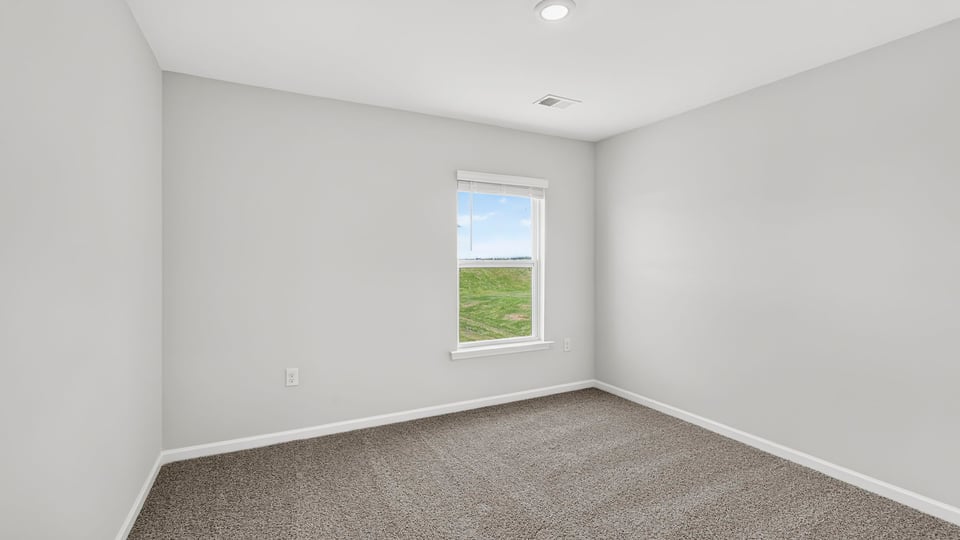 Bedroom with carpet and windows.