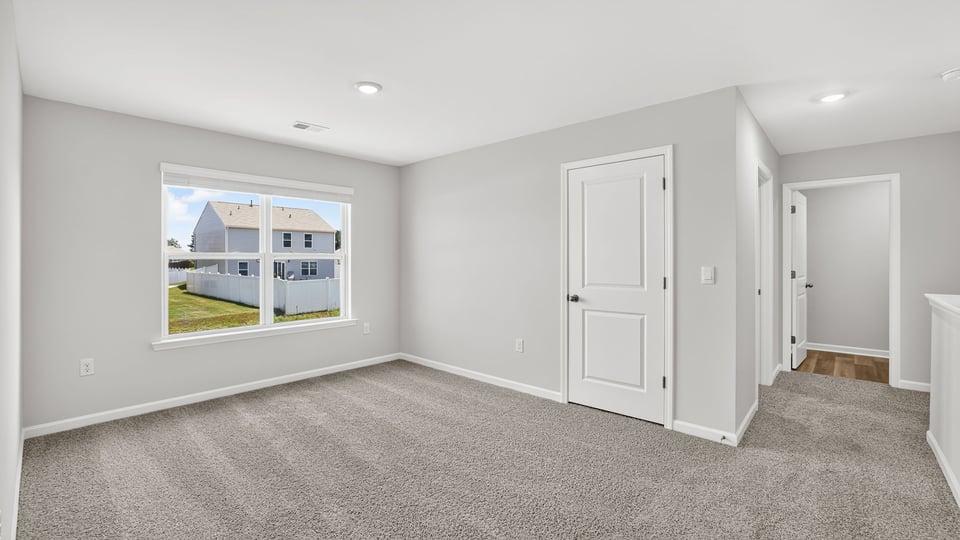 Loft area with carpet and windows.