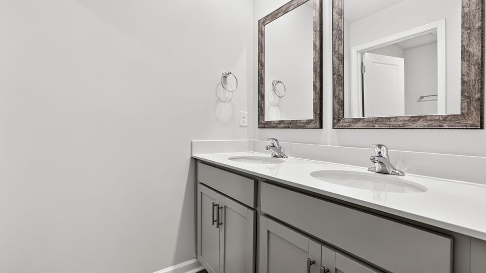 Bathroom with vanity sinks.