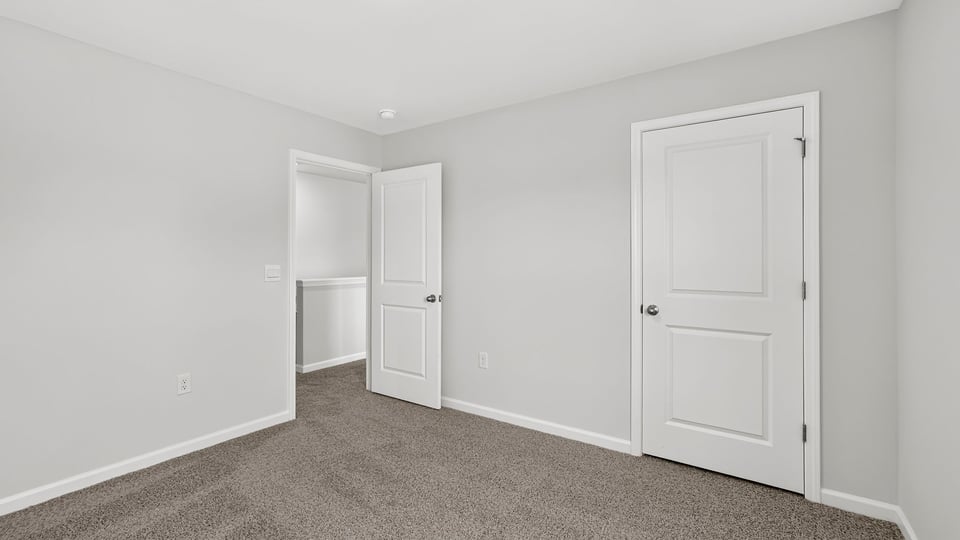 Bedroom with carpet and window.