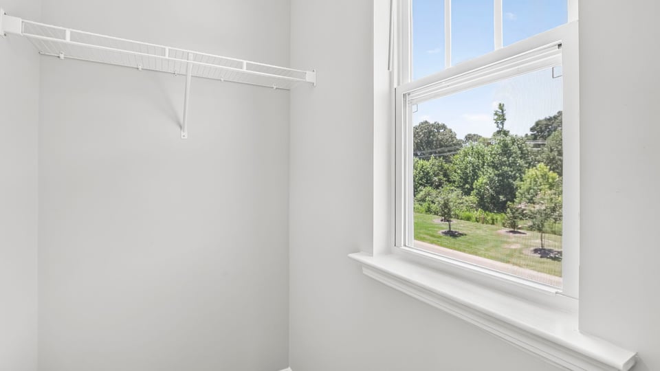 Primary closet with window.