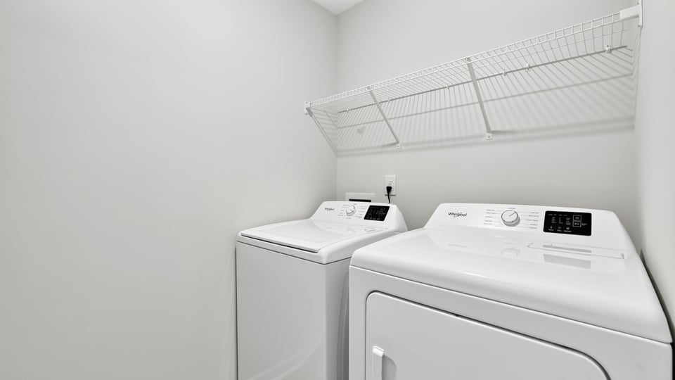 Laundry room with shelf.