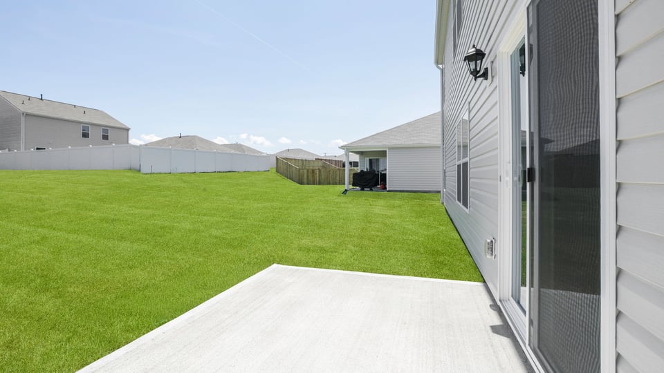 Back exterior with large backyard.