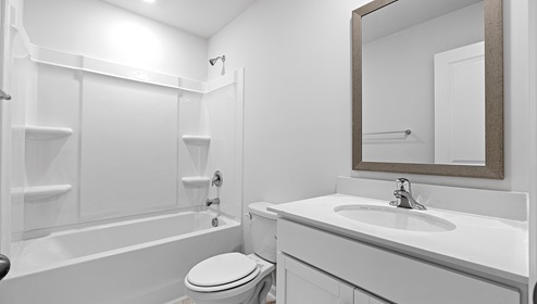 Bathroom with tub and single vanity sink.