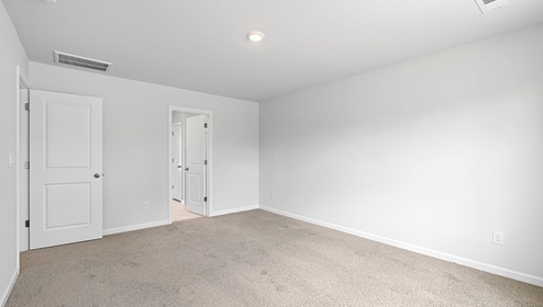 Bedroom with carpet and window.