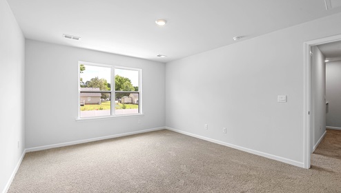 Bedroom with carpet and window.