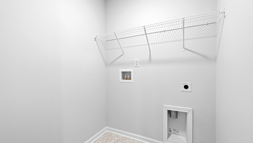 Laundry room with hanging storage shelves.
