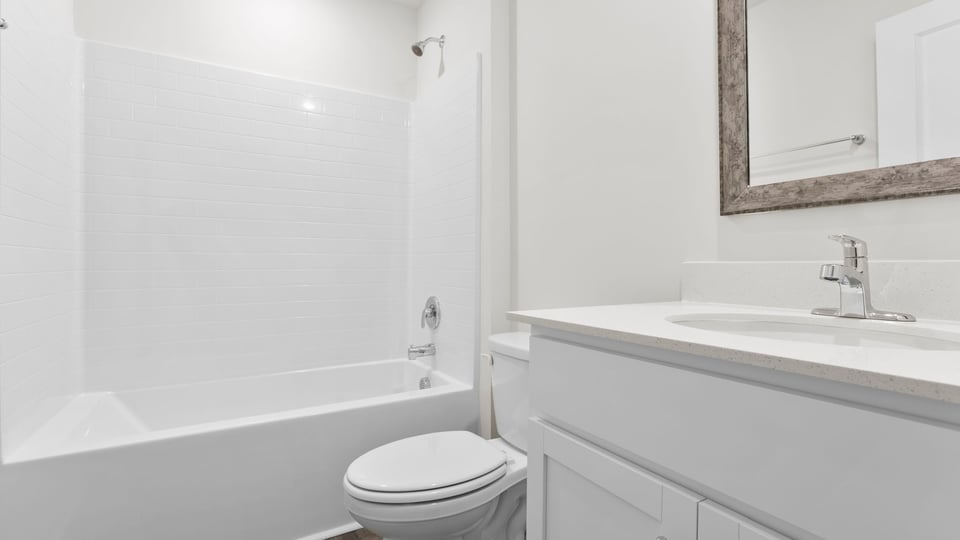Bathroom with single vanity sink and bathtub.