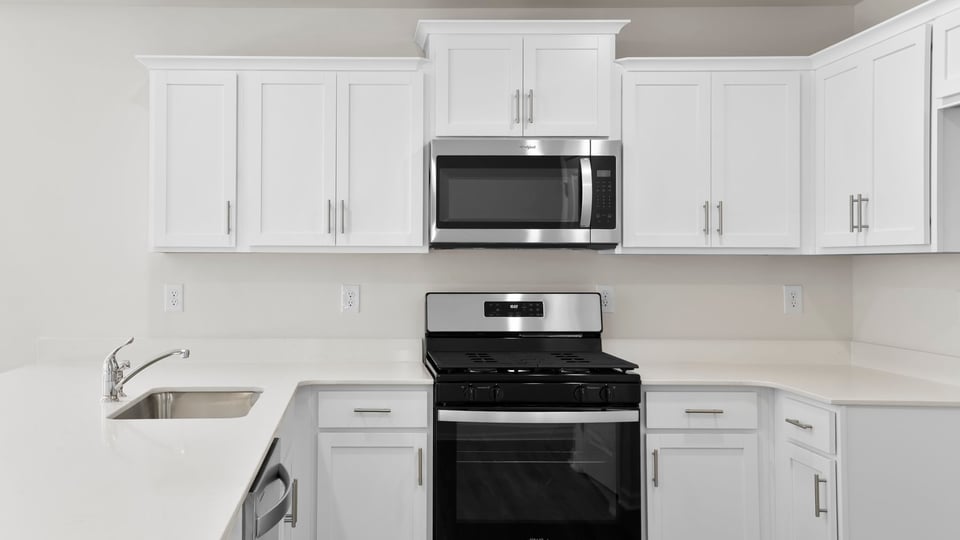 Kitchen with counters and stainless steel appliances.