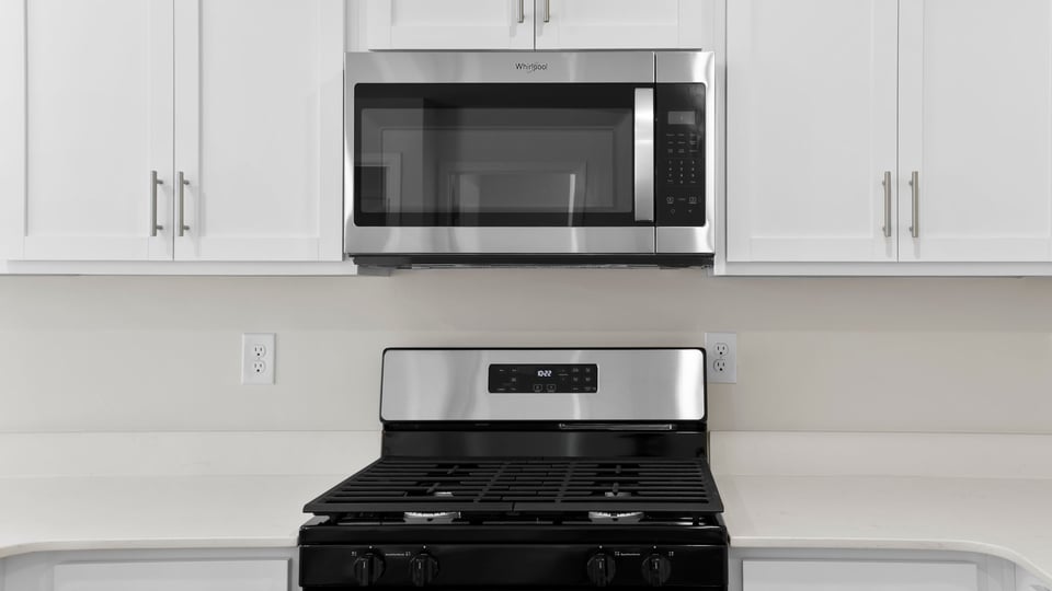 Kitchen with counters and stainless steel appliances.