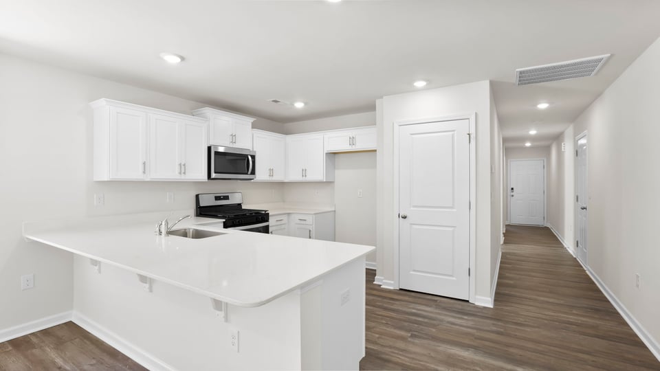 Kitchen with counters and stainless steel appliances.