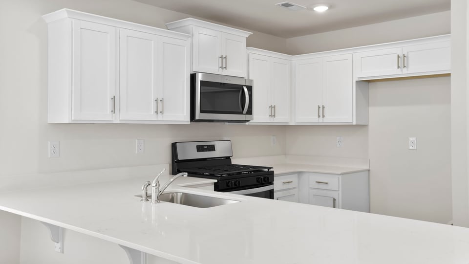 Kitchen with counters and stainless steel appliances.