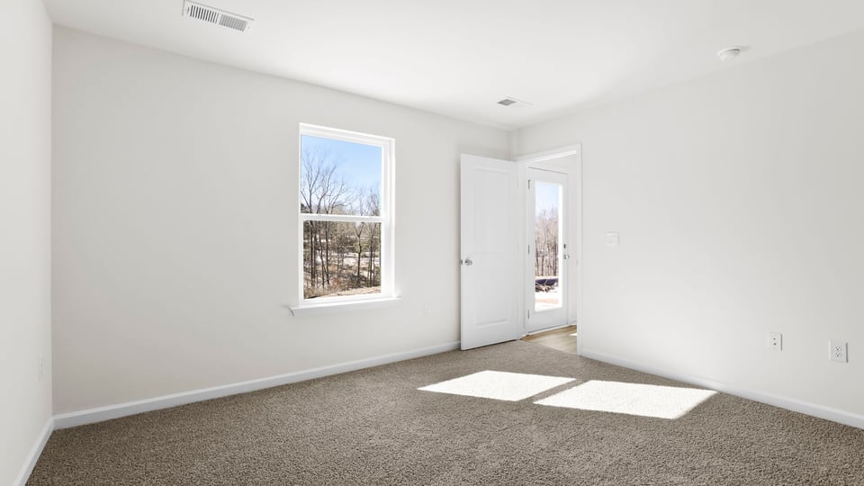 Bedroom with carpet and window.