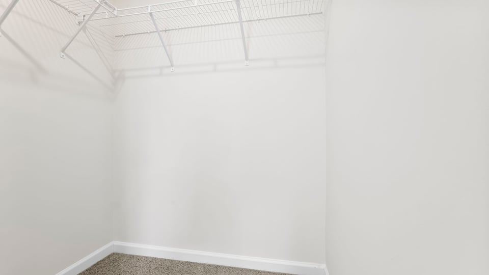 Closet with hanging storage racks.