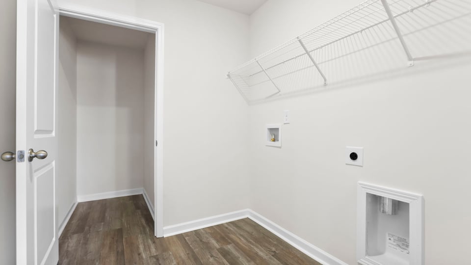 Laundry room with hanging storage racks.