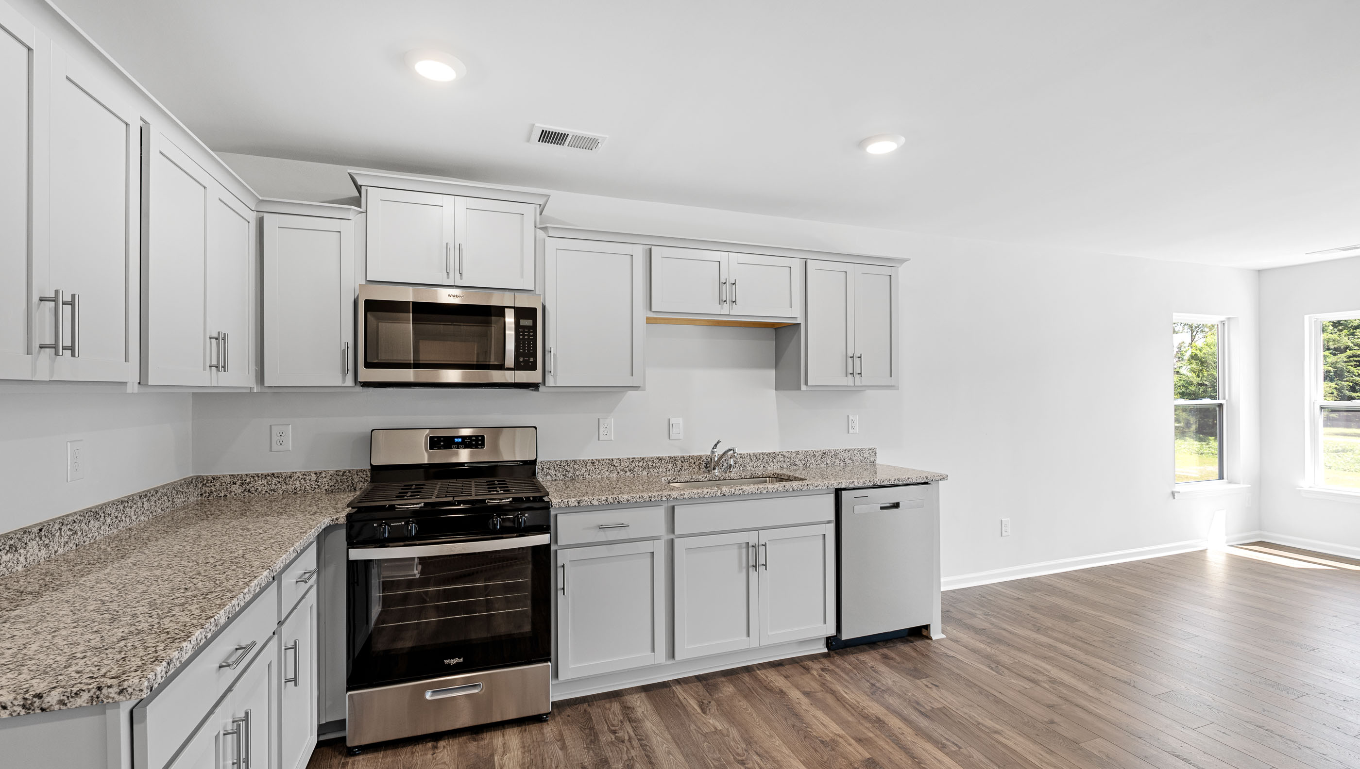 Kitchen and island with granite counter tops.