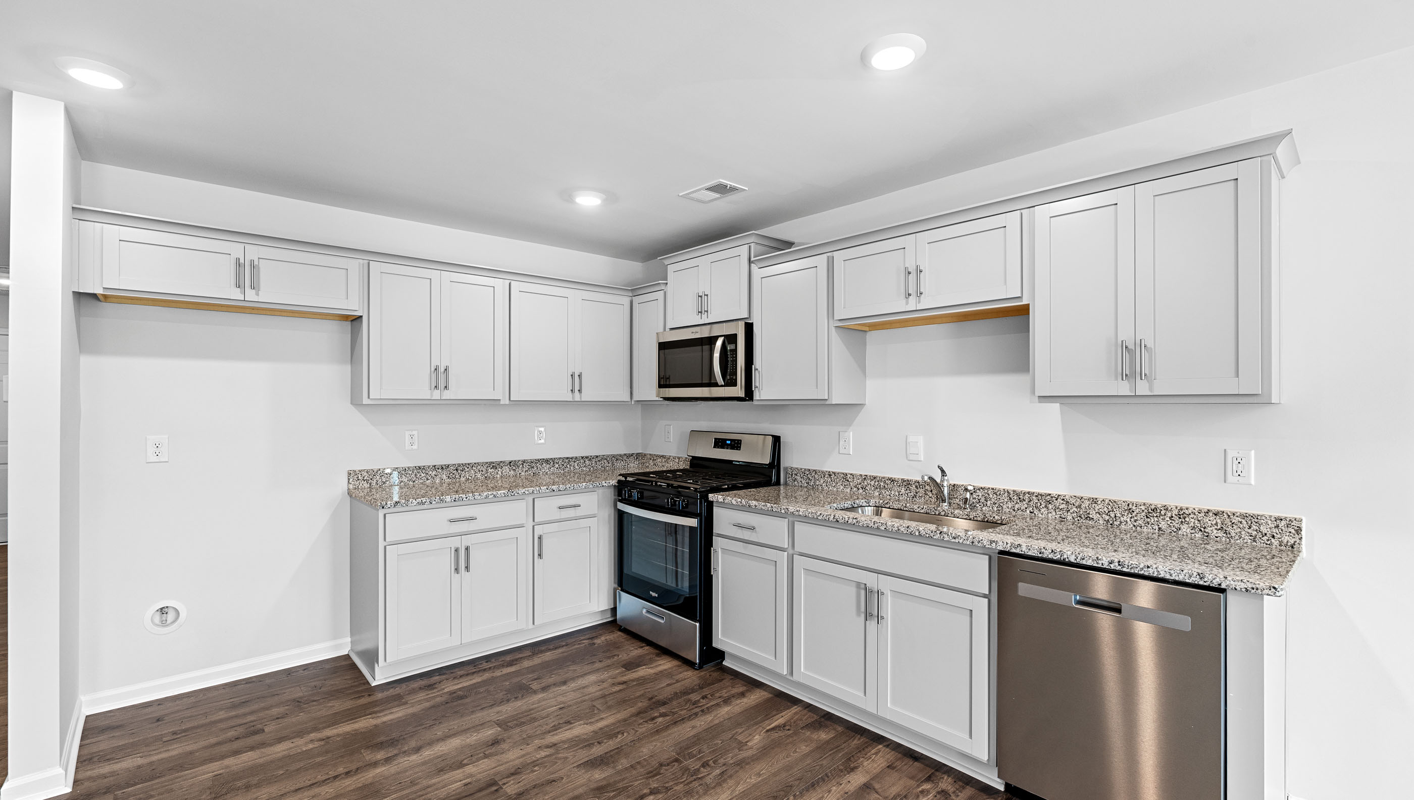 Kitchen and island with granite counter tops.
