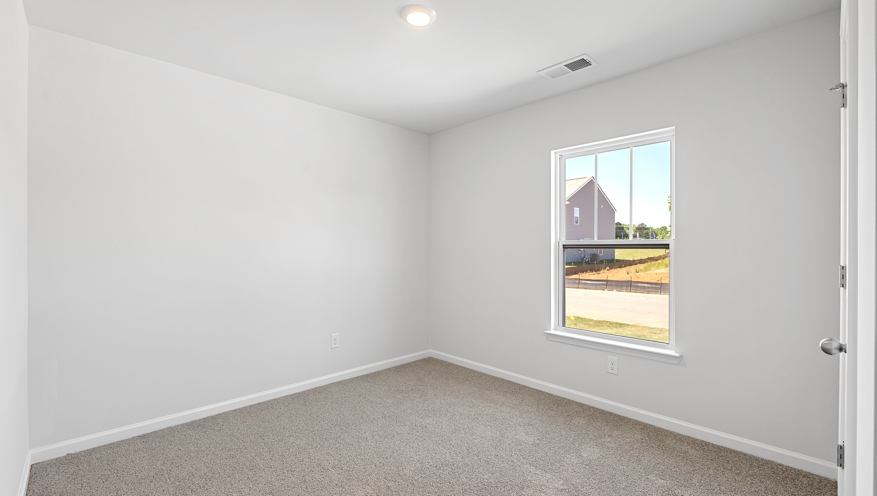 Bedroom with carpet and windows.