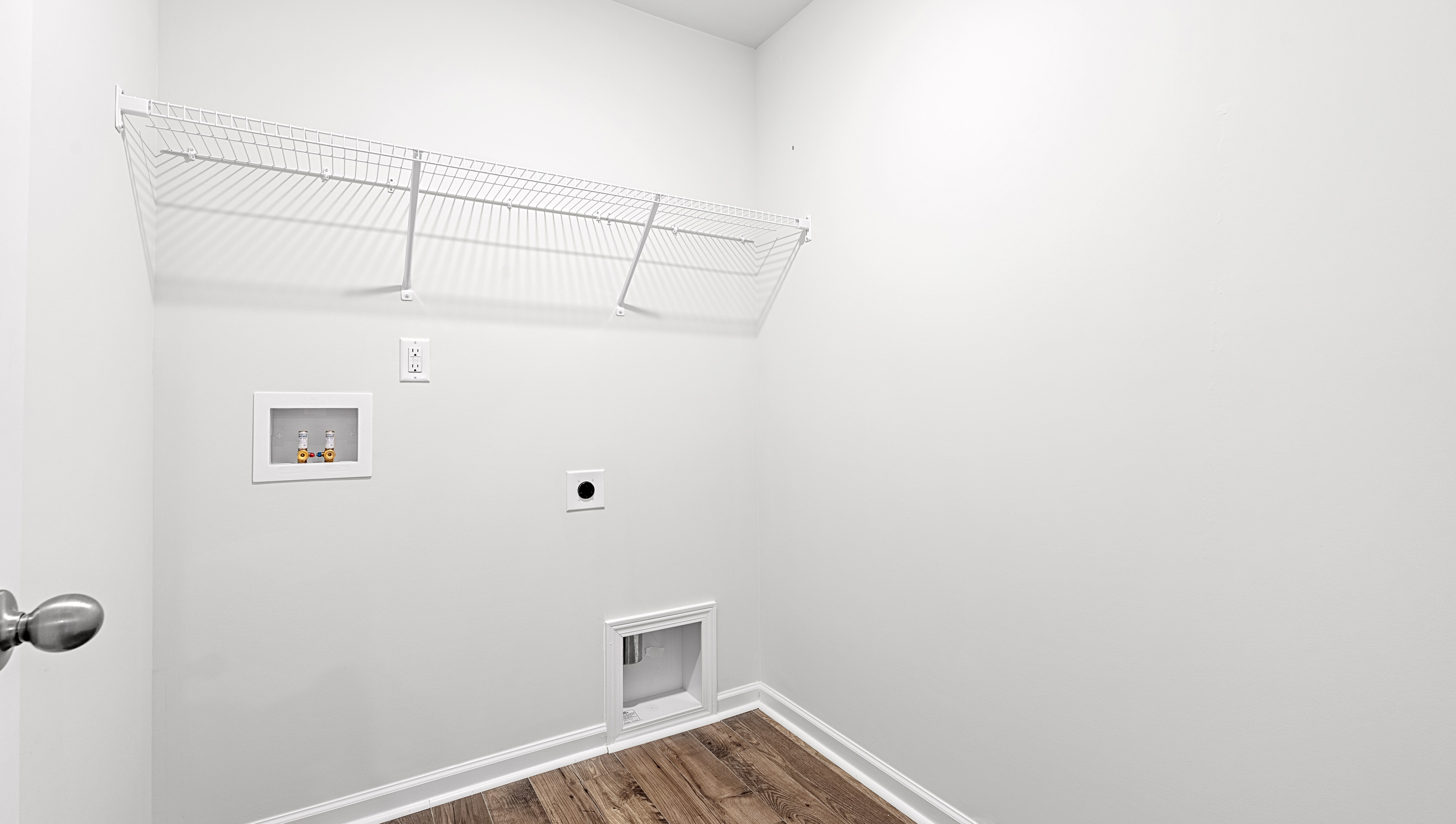 Laundry room with hanging storage racks.