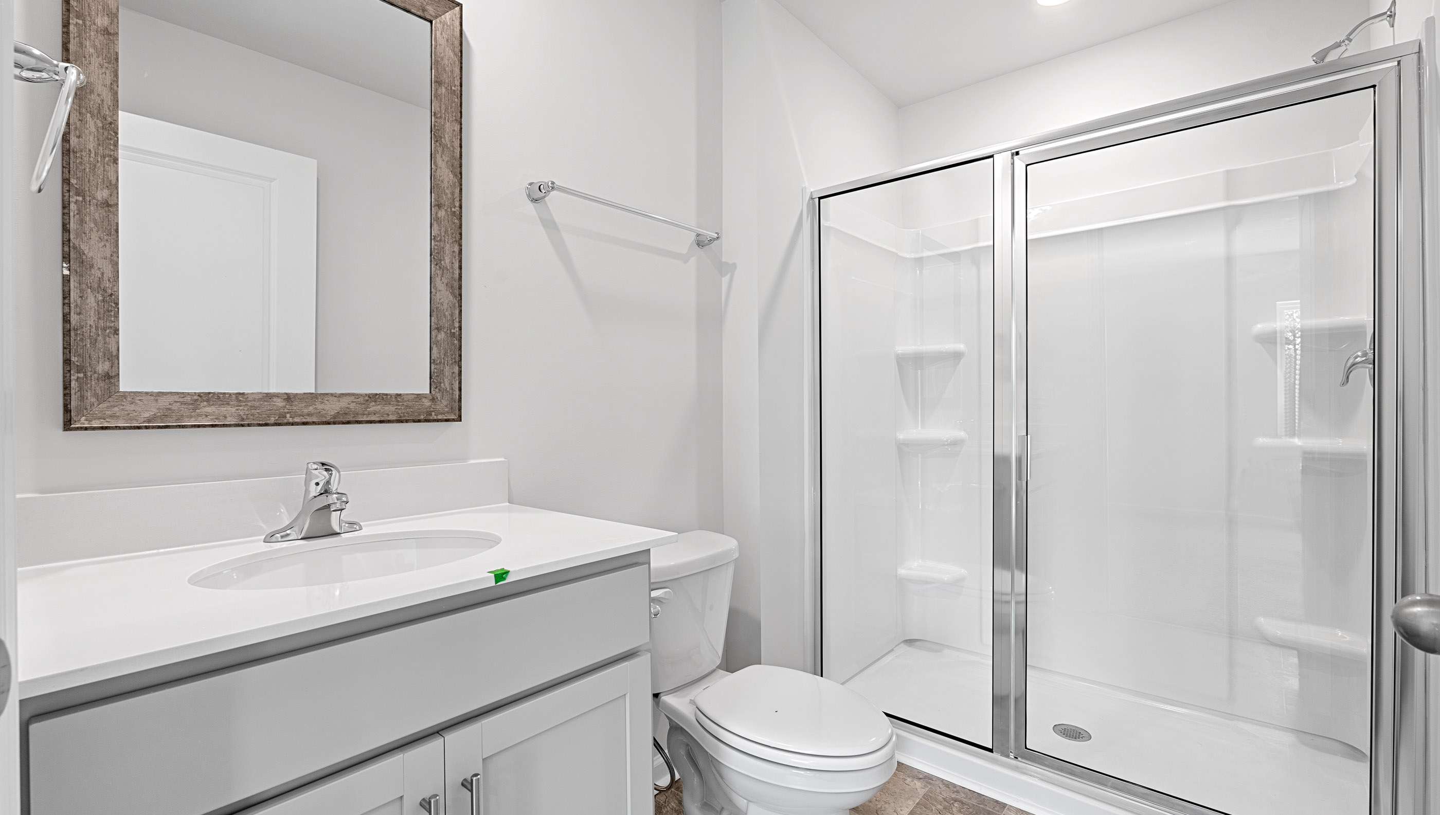 Bathroom with shower and single vanity sink.