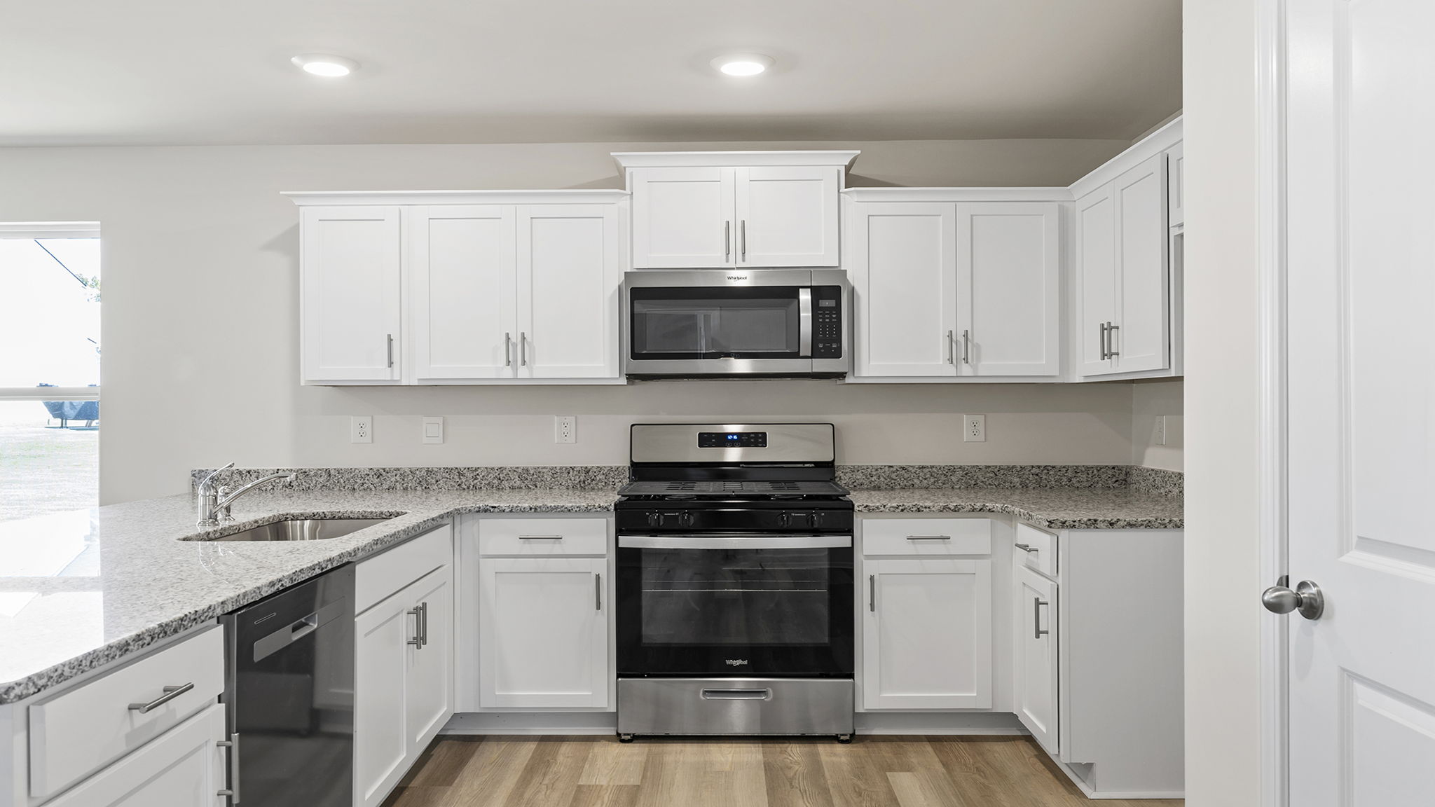 Kitchen and island with granite counter tops.