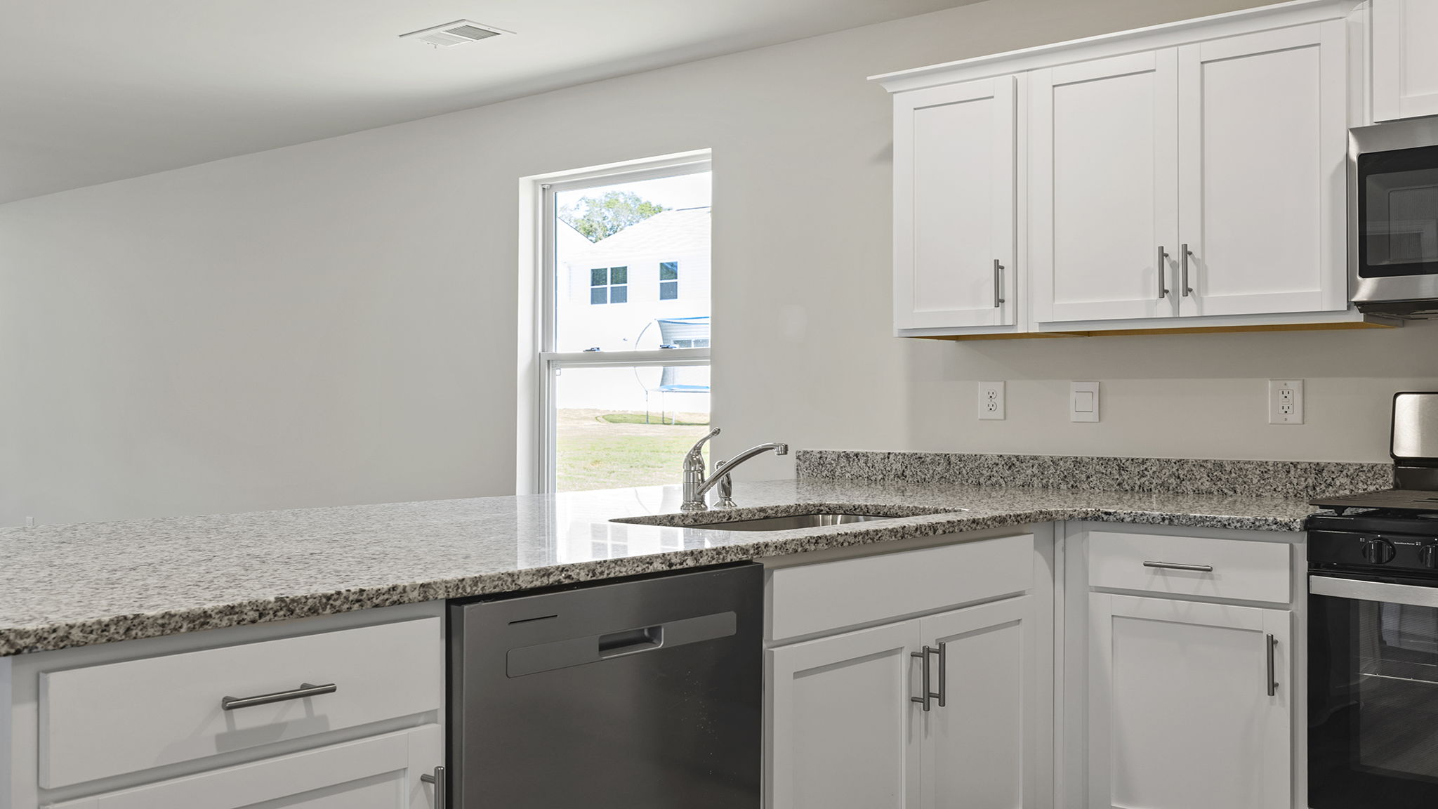 Kitchen and island with granite counter tops.