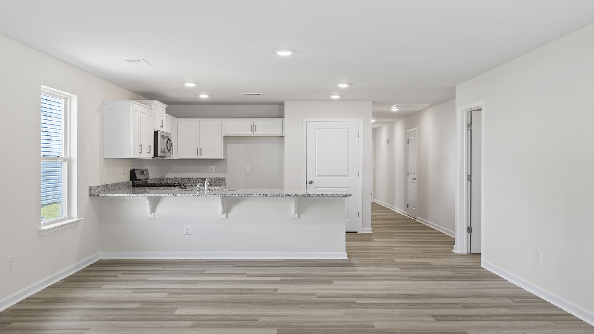 View of family room and kitchen.