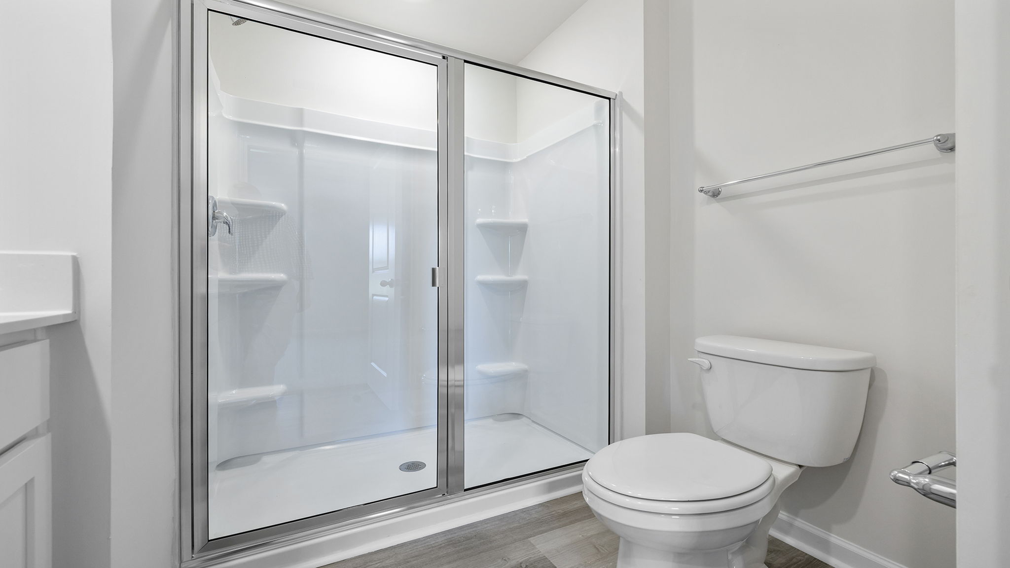 Bathroom with double vanity sink and walk in shower.