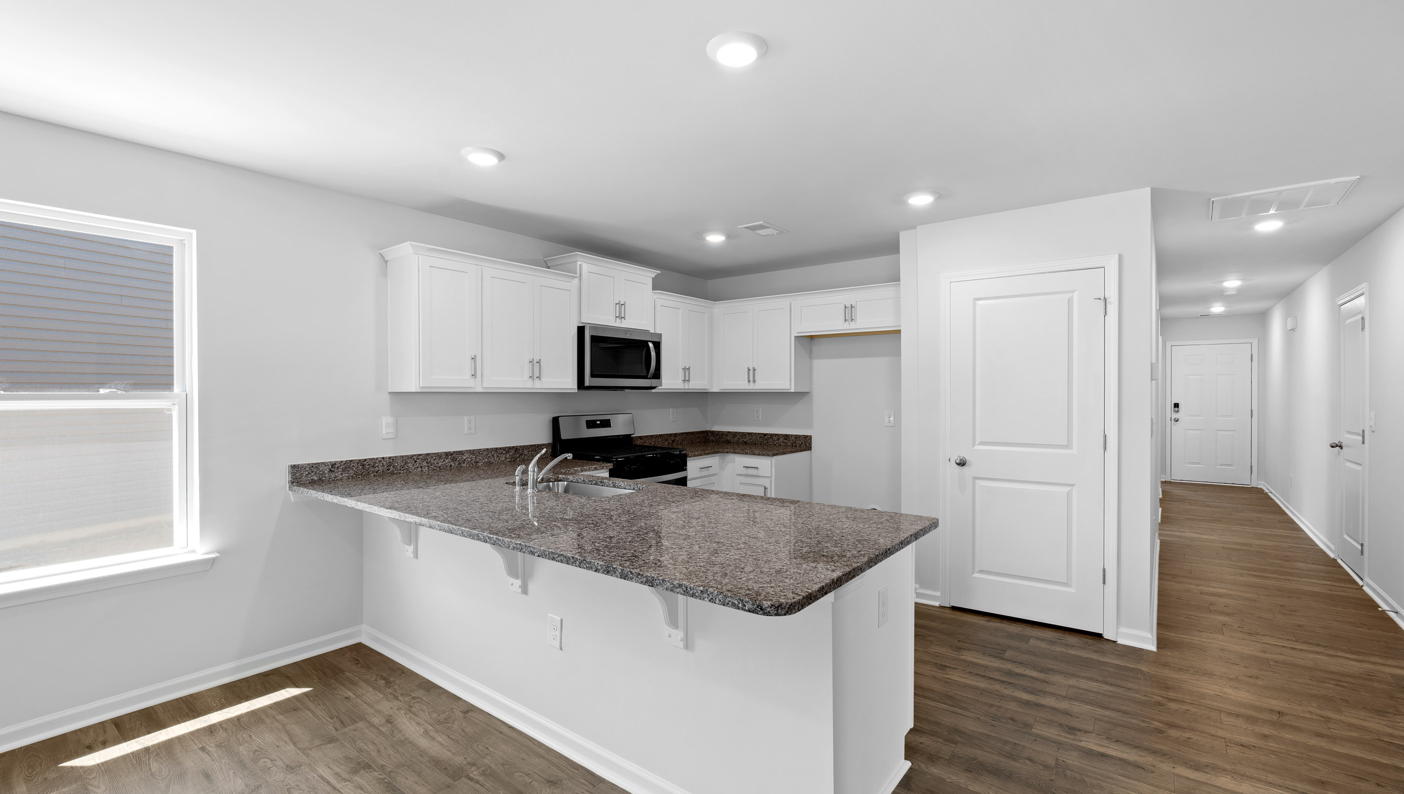 Kitchen with granite counter tops and stainless steel appliances.