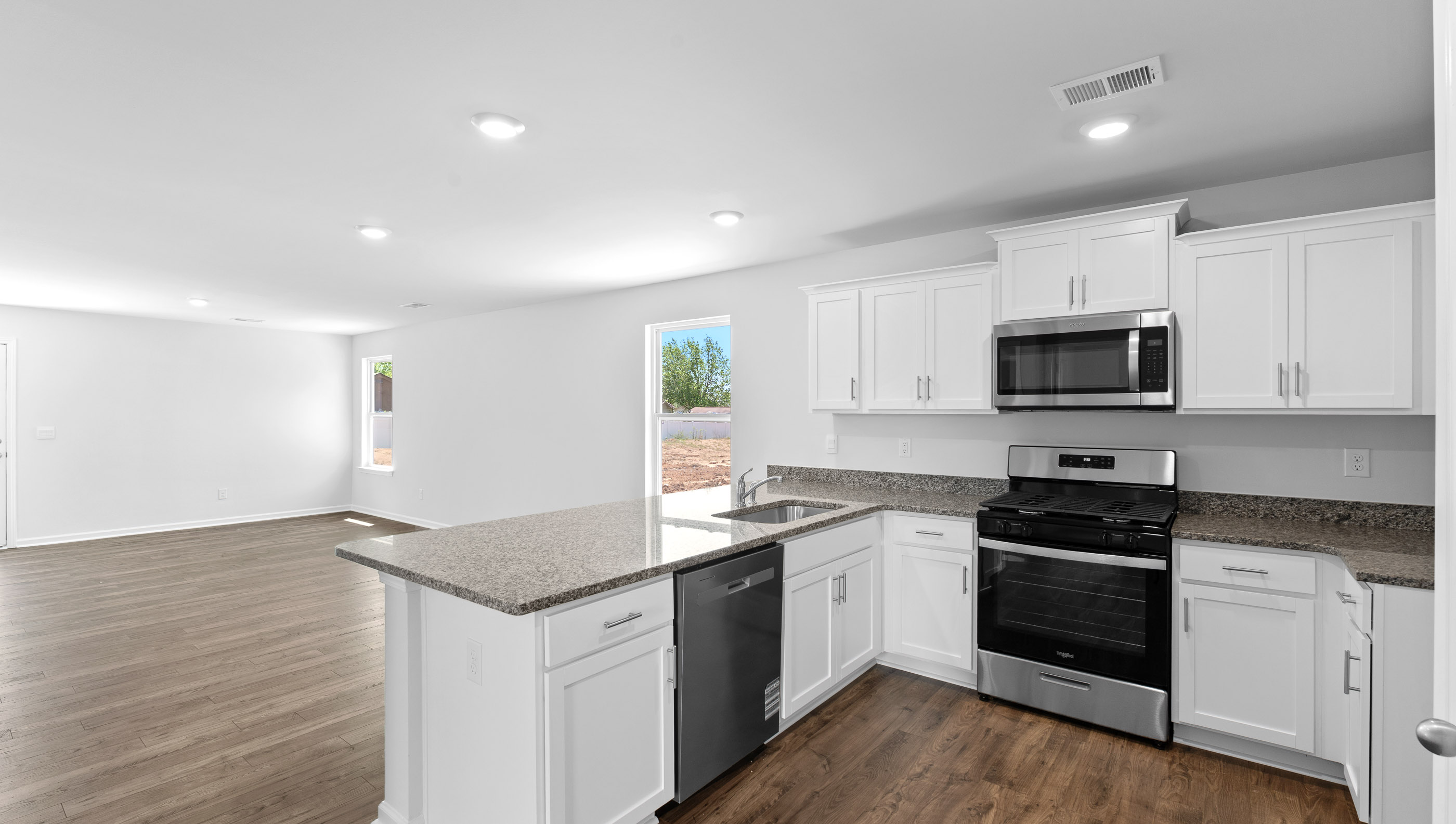 Kitchen with granite counter tops and stainless steel appliances.