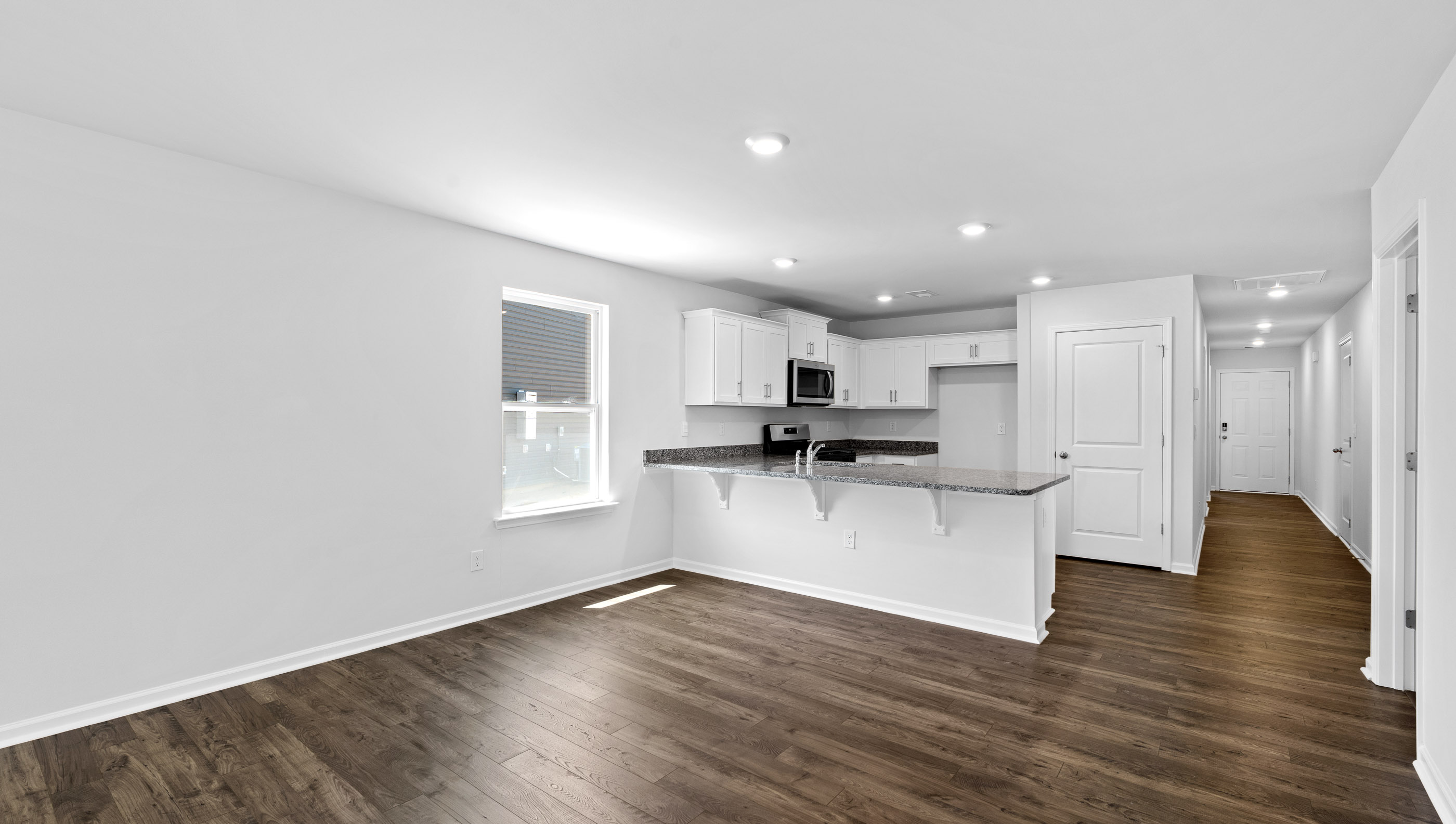 Kitchen with granite counter tops and stainless steel appliances.