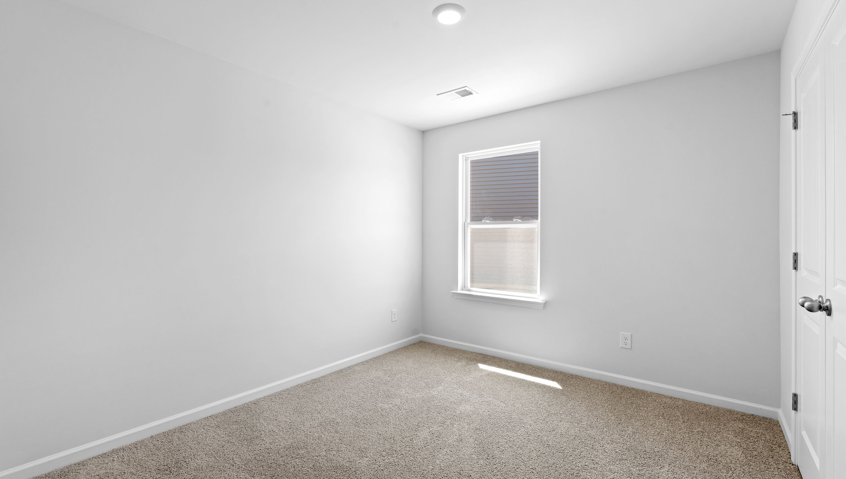 Bedroom with carpet and window.