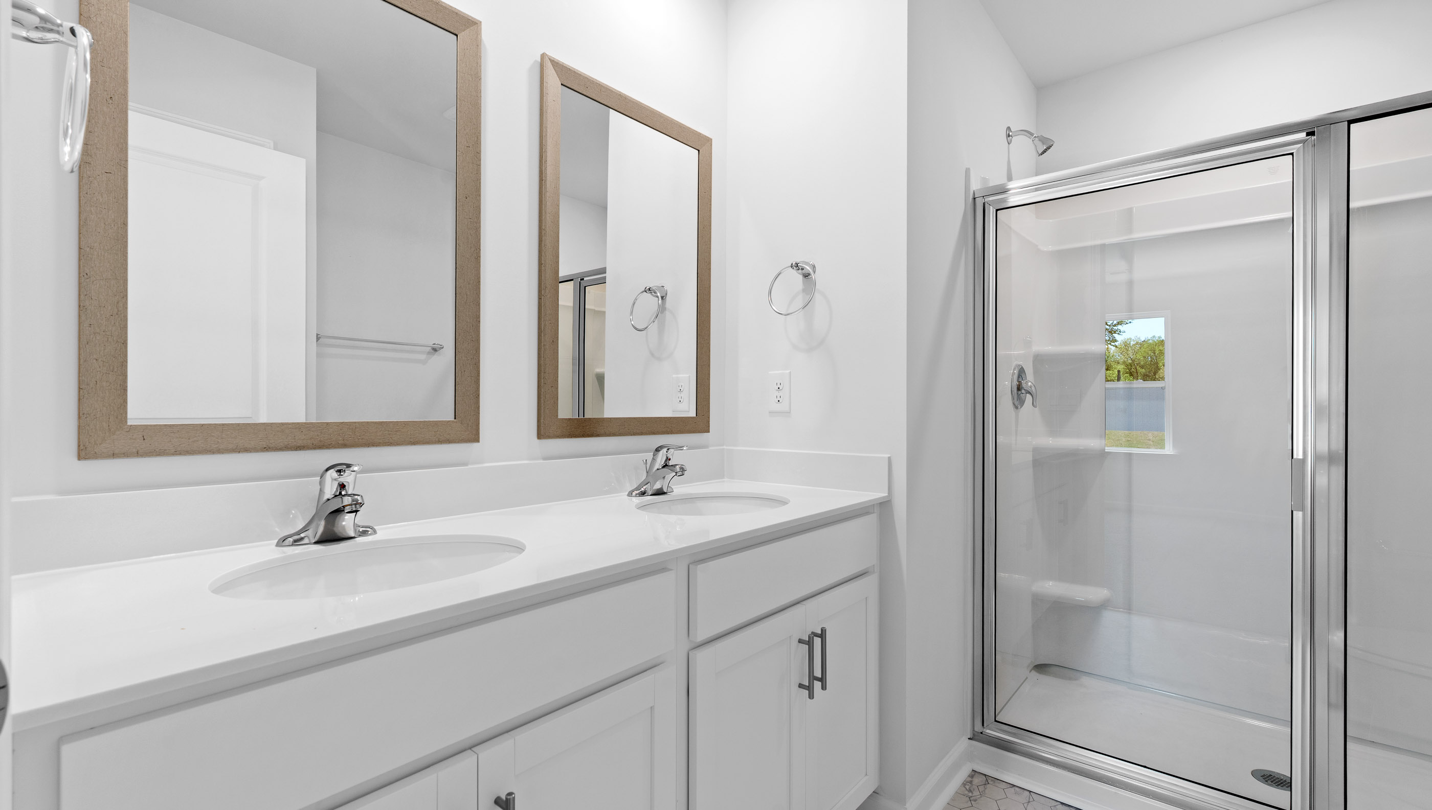 Bathroom with shower and double vanity sink.
