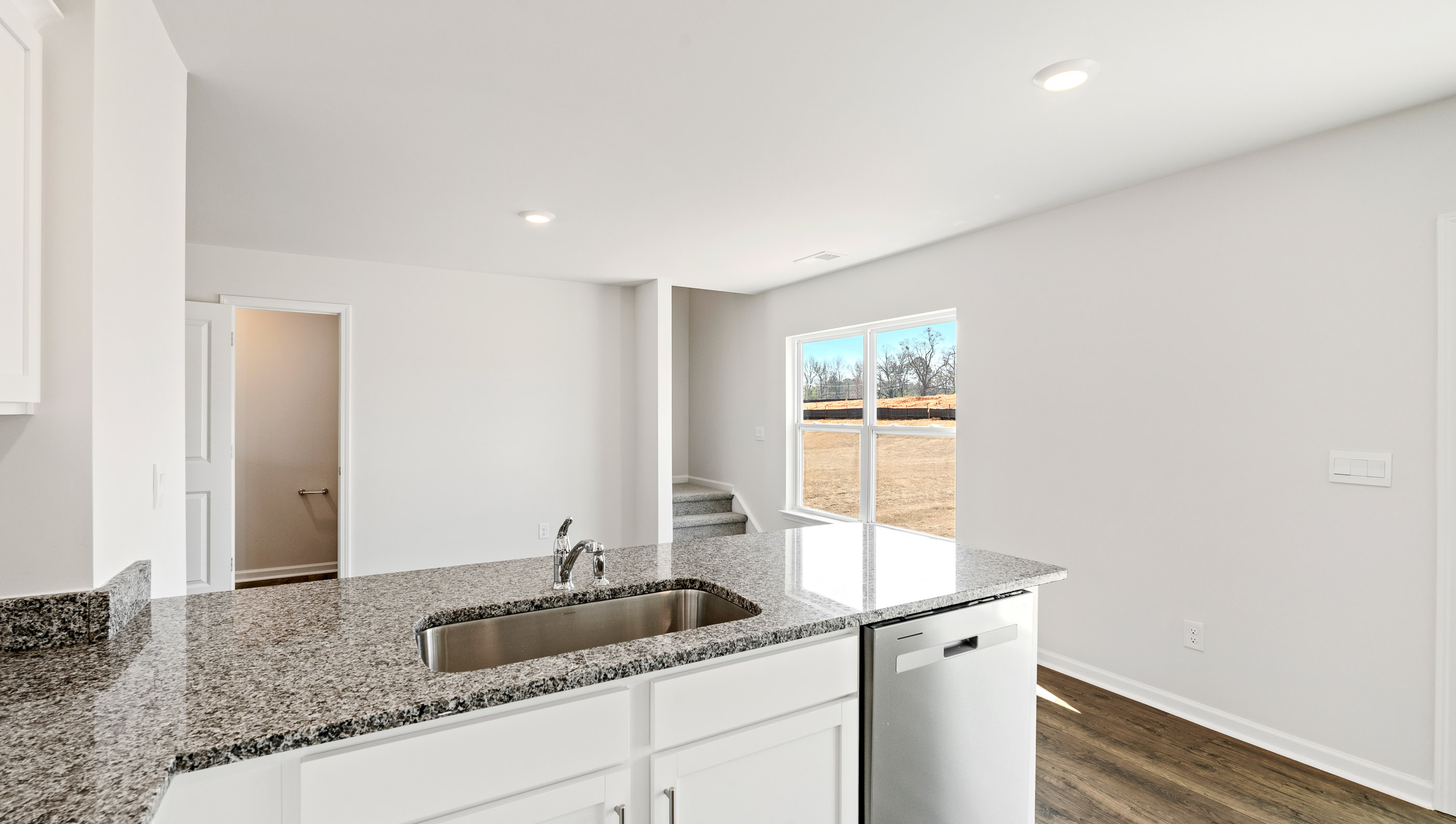 Kitchen and island with granite counter tops.