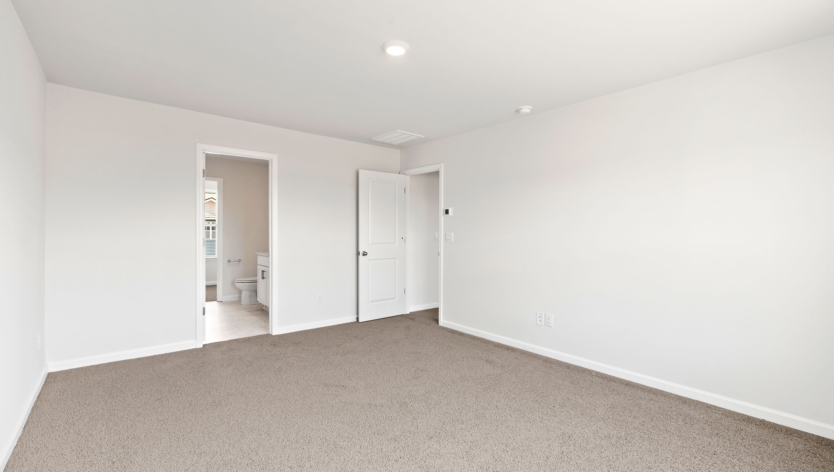 Bedroom with carpet and window.