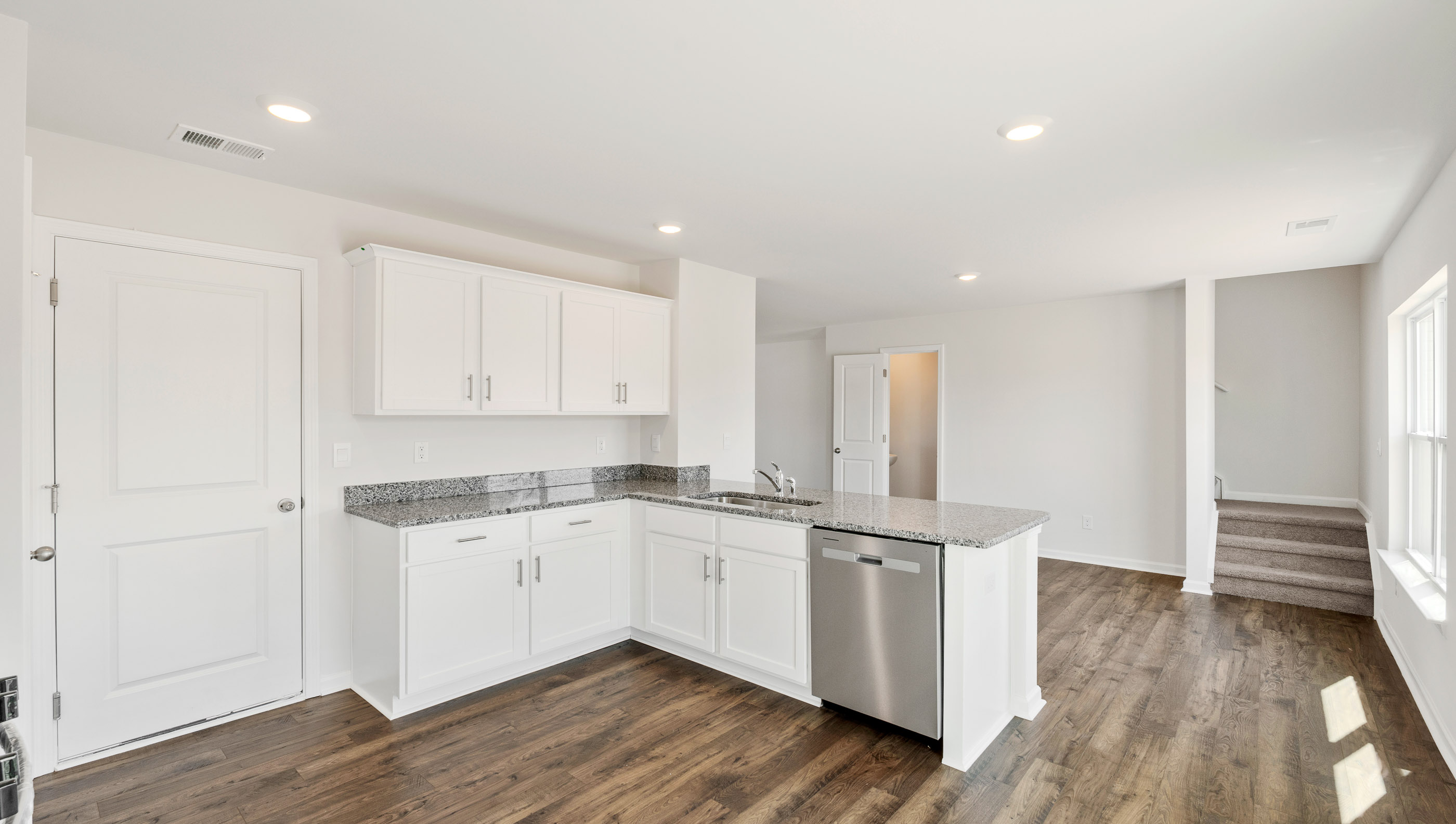Kitchen and island with granite counter tops.