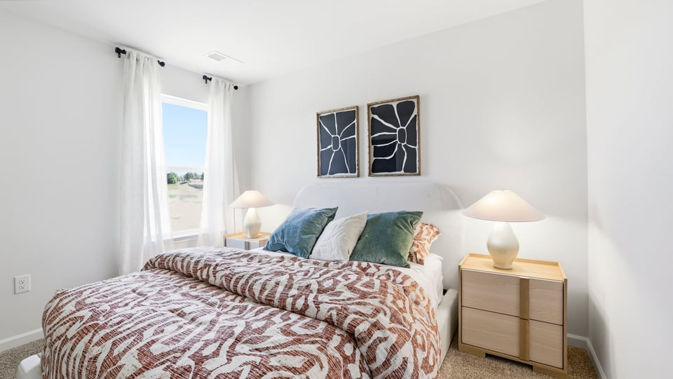 Bedroom with carpet and window.a