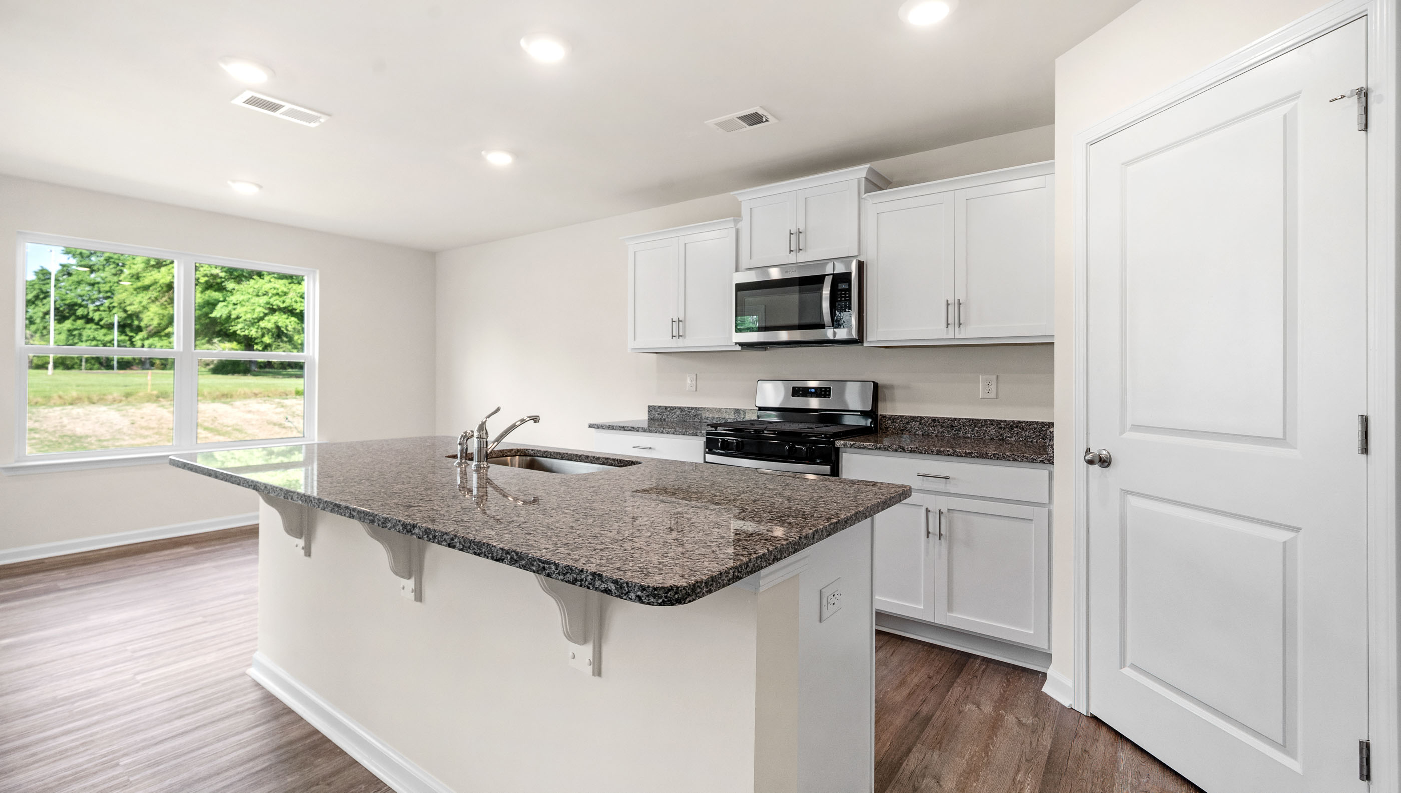 Kitchen and island with granite counter tops.