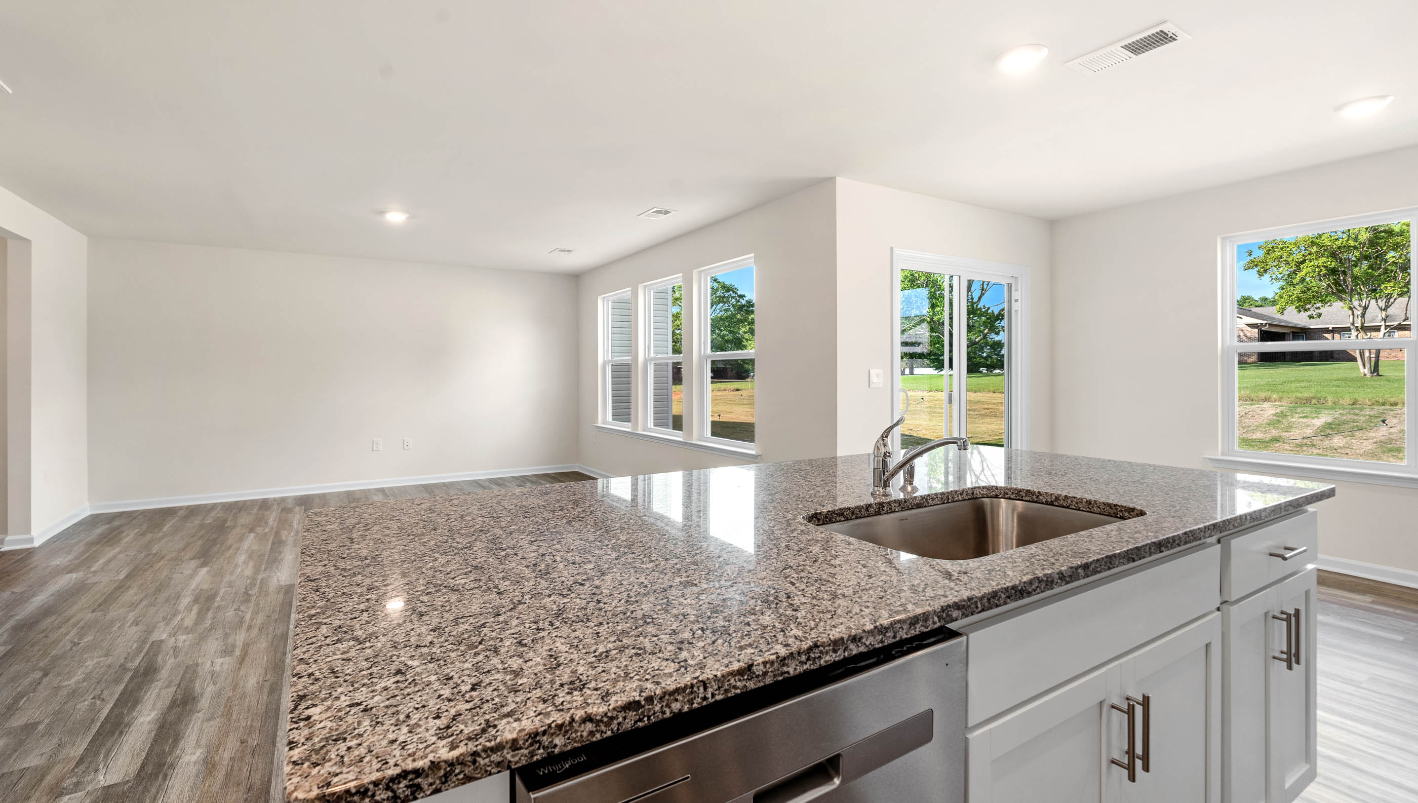 Kitchen and island with granite counter tops.