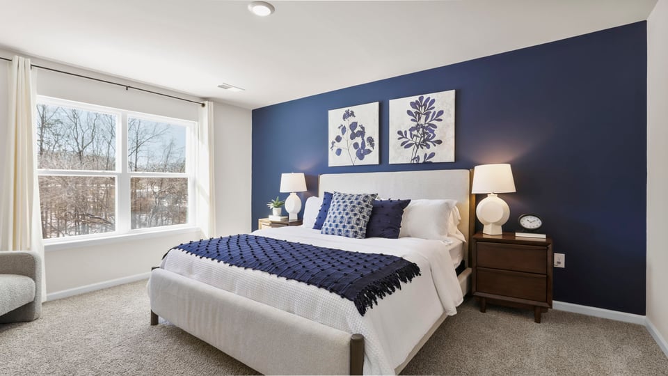 Primary bedroom with window and carpet.