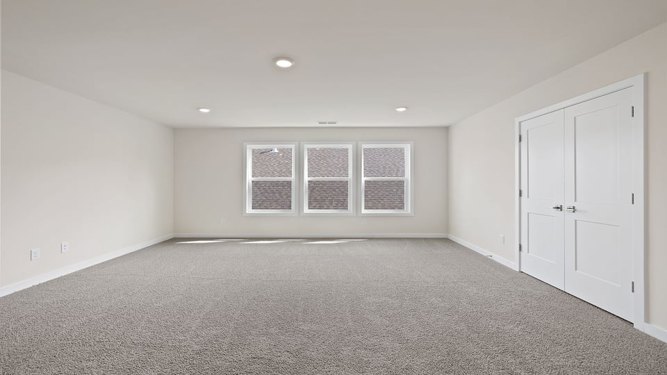 Loft with carpet and windows.