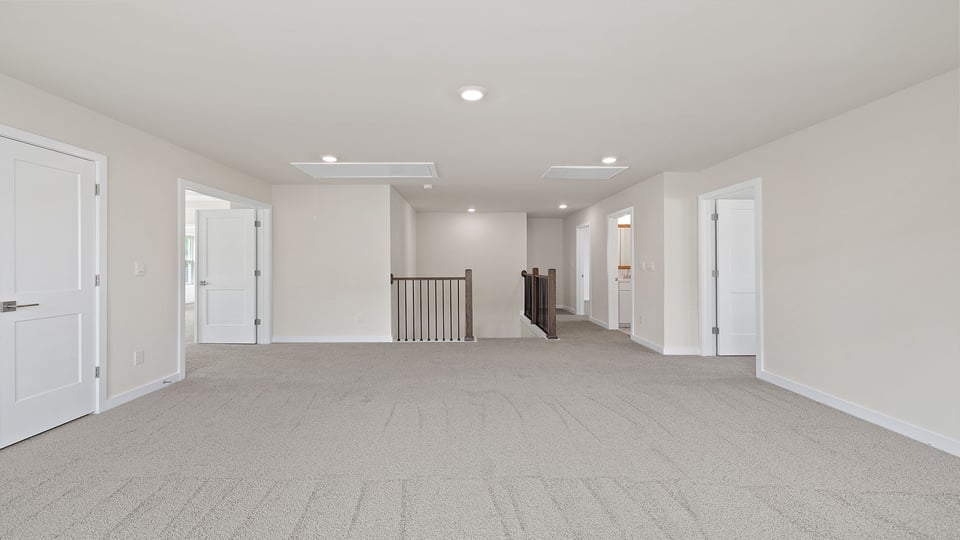 Loft with carpet and windows.