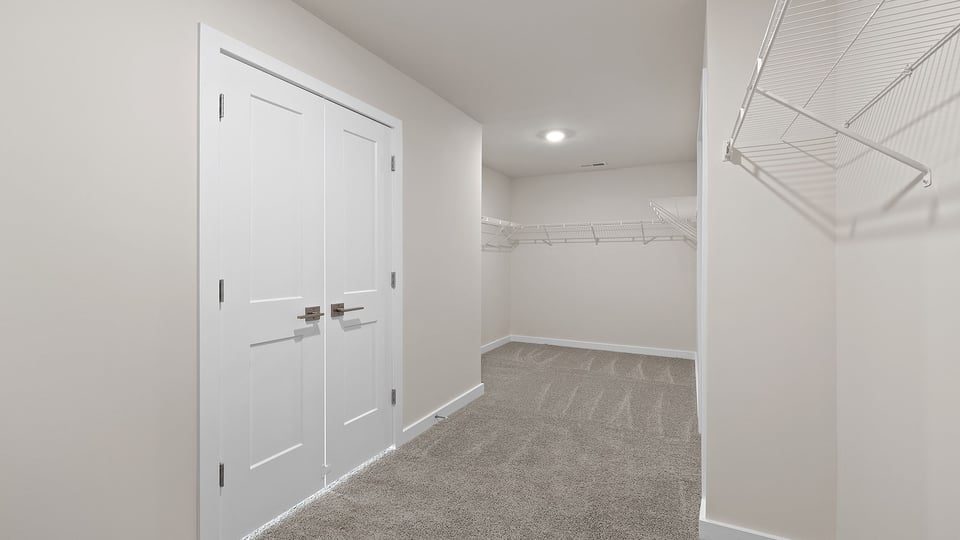 Primary closet with shelf.